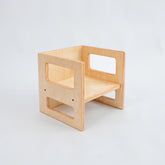 A natural wooden Montessori cube chair with rounded edges and a simplistic design, placed against a white background.